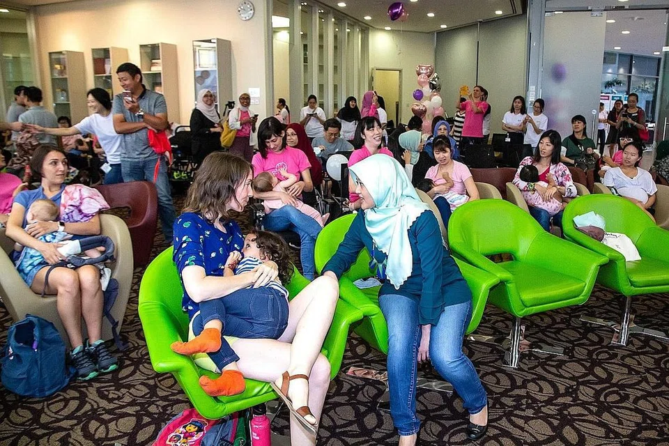PEJUANG PEMBERI SUSU BADAN: Cik Rahayu Mahzam (kanan, bertudung) beramah mesra dengan peserta acara penyusuan bayi secara serentak atau Big Latch On di Hospital Universiti Nasional baru-baru ini. - Foto BH oleh ZALEHA ABDUL KADER