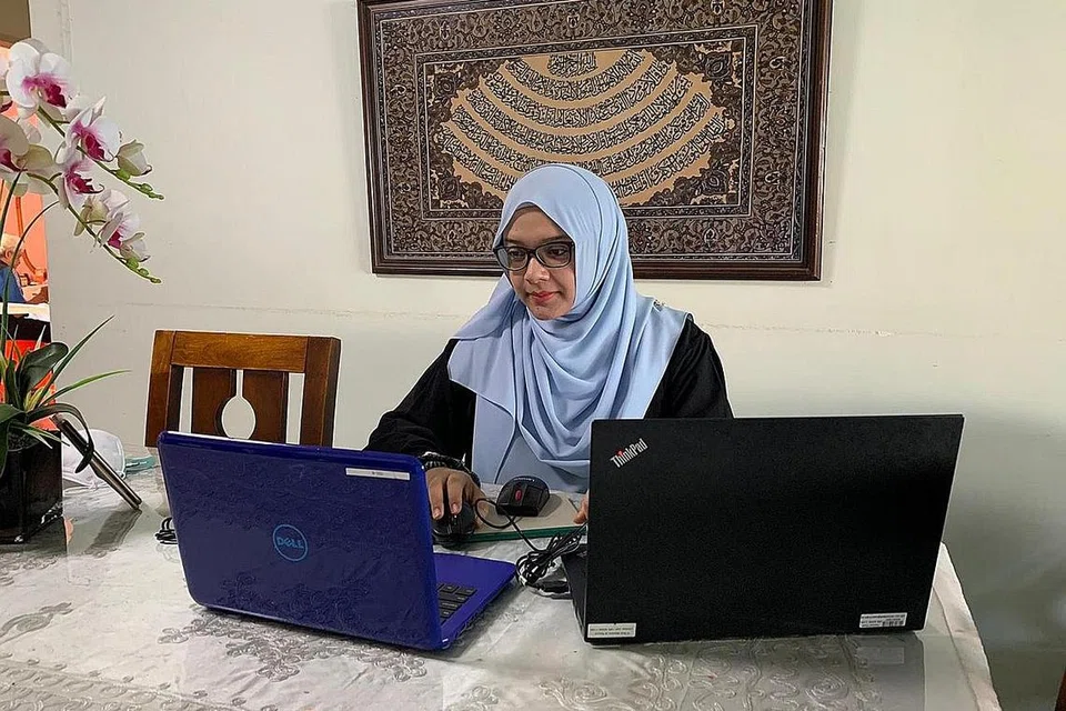 KERJA DI RUMAH: Cik Nurazlin Aniba, Pengurus Pembangunan Sosial bagi kelompok masjid daerah timur (EMC) yang berusaha untuk memastikan bantuan kewangan tetap berlangsung. - Foto ihsan NURAZLIN ANIBA 