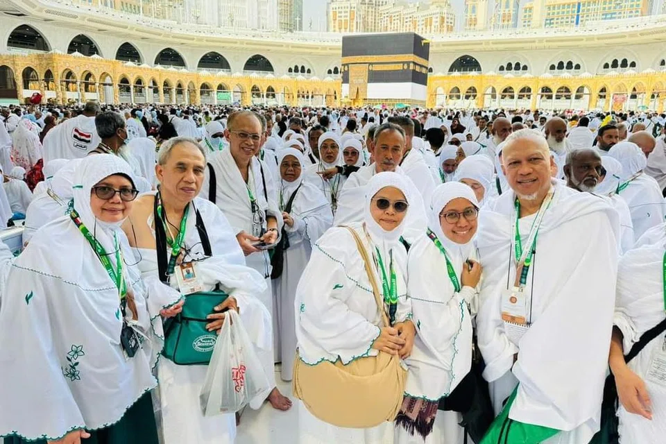 Encik Abdul Hasim Abdul Hamid (kanan) bergambar bersama isterinya, Faridah Ahmad (tiga dari kanan); dan adiknya, Cik Harlizah Abdul Hamid (dua dari kanan), selepas menunaikan tawaf umrah mereka yang pertama pada 9 Jun.