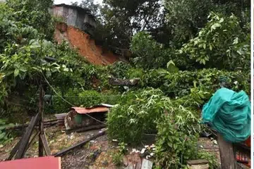 Tanah runtuh yang meranapkan sebuah rumah yang didiami dua beranak di Kampung Lok Bonu, Sepanggar, Sabah.