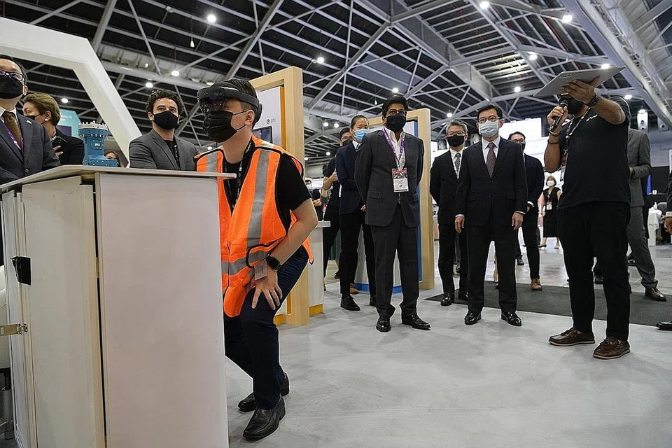 TINJAU TEKNOLOGI BARU: Encik Heng Swee Keat (dua dari kanan) mengunjungi kios Microsoft di ITAP 2021 di mana seorang pegawai menunjukkan HoloLens, iaitu sepasang cermin mata pintar realiti campuran yang dibangunkan dan dihasilkan oleh Microsoft, semalam. - Foto BH oleh NG SOR LUAN