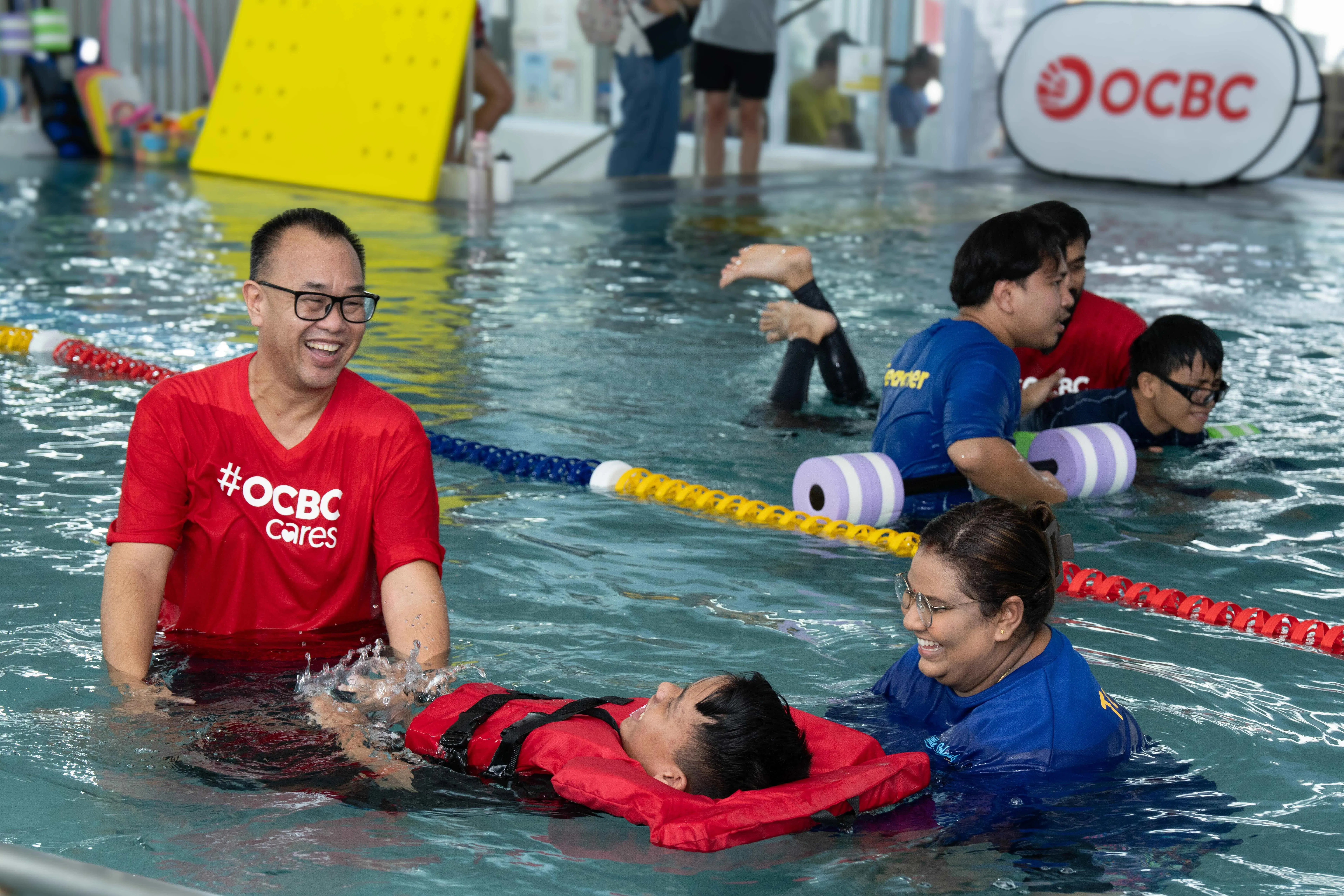 Former national water polo player Samuel Wong (far left) is one the volunteers guiding participants of the OCBC-SDSC SwimTogether programme.