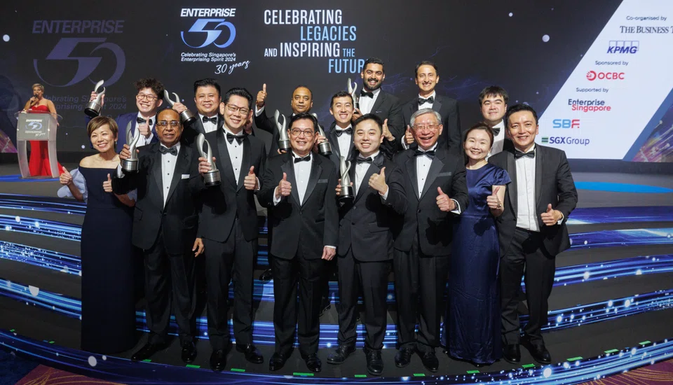 The top 10 E50 Award winners with guest of honour DPM Heng Swee Keat (front row, fourth from left) and officials, KPMG Singapore's Lee Sze Yeng (front row, left); OCBC's Linus Goh (front row, third from right); BT’s Chen Huifen (front row, second from right) and KPMG Singapore's Chiu Wu Hong (front row, right).
