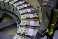 Freshly printed US dollar notes in 2018. US dollar strength has a negative ripple effect on the global economic recovery