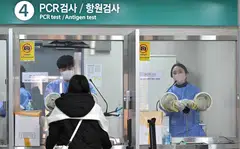 A health worker takes a nasal swab from a traveller arriving from China at a Covid-19 testing centre at Incheon International Airport, west of Seoul on Jan 3, 2023. 