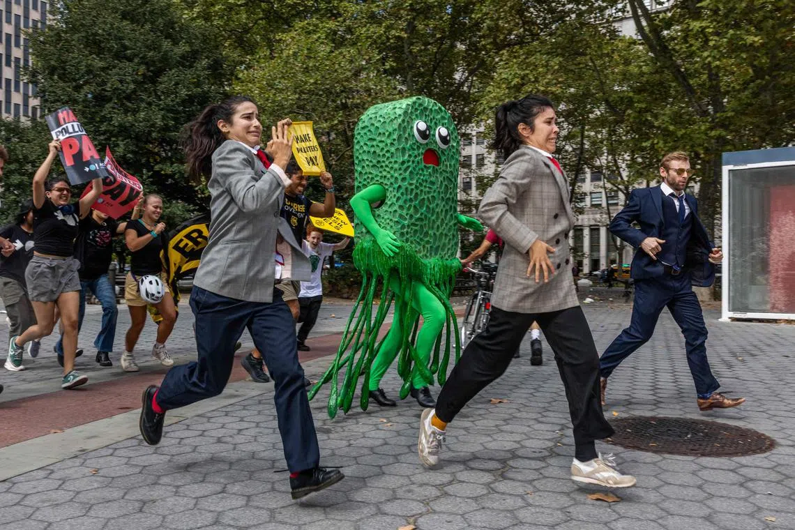 A "greenwashing" character chasing activists during a climate demonstration in New York City. There is now greater enforcement over greenwashing claims, with stricter penalties and more detailed reporting requirements becoming the norm.