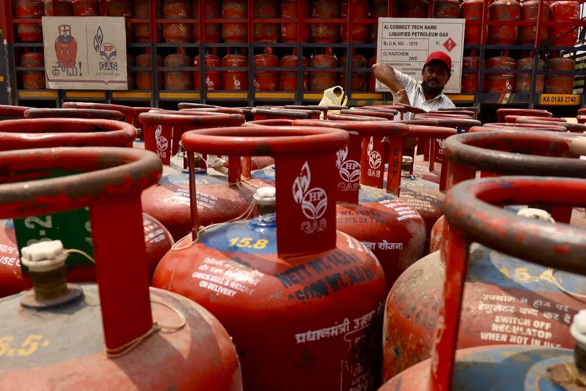 epa12825147 A man arranges empty liquefied petroleum gas (LPG) cylinders at a gas agency office in Bangalore, India, 16 March 2026. Gas supply concerns have emerged in cities such as Delhi, Mumbai, and Bangalore as the ongoing Middle East conflict disrupts parts of the supply chain in India.  EPA/JAGADEESH NV