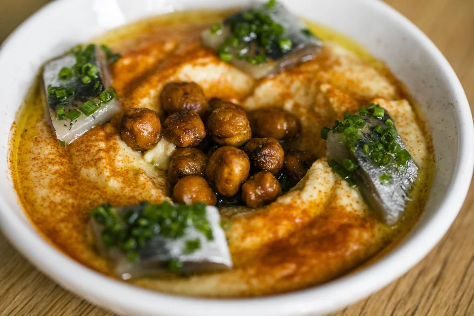 Hummus with crispy chickpeas and smoked sardines. The chickpeas' earthiness and the lingering briny finish make an attractive combination.