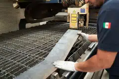 A worker cuts steel sheets at an auto parts manufacturer in San Luis Potosi, Mexico, Feb 17, 2025. The value of Mexico's exports to the United States now far exceeds that of its imports from its northern neighbour - a major bone of contention for Donald Trump.