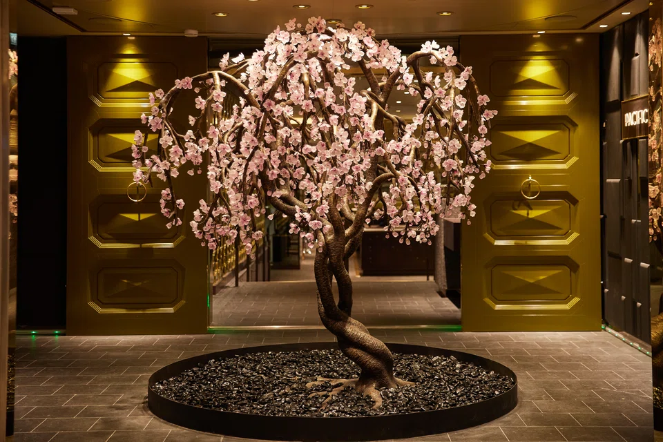 This custom-made bronze and glass bonsai cherry sculpture is part of the ship's extensive art collection.