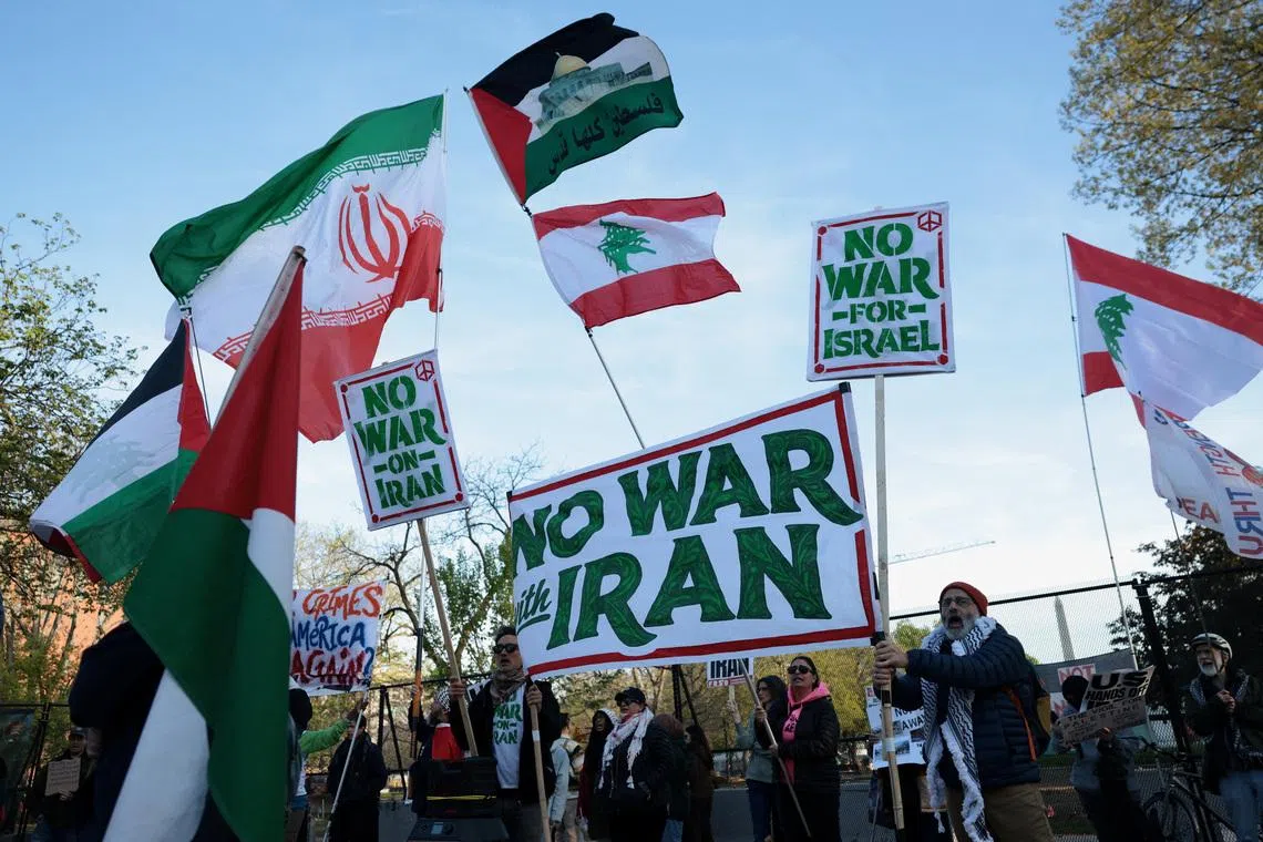 People protest against military action in Iran near the White House in Washington on Apr 8. 