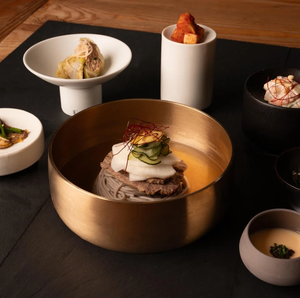 Naengmyeong are noodles in a cold broth topped with beef and pear slices.