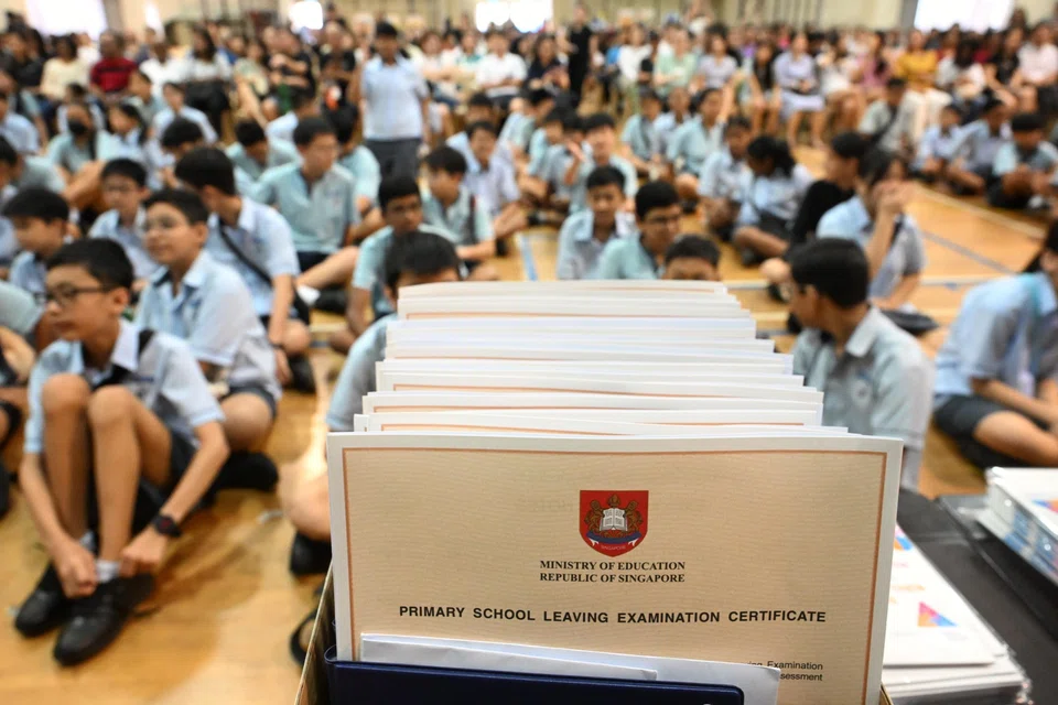 Pupils of Anchor Green Primary School waiting to receive their PSLE results last November. Since the "best" schools are determined largely by their students' academic scores, the focus is on academics and exam results.
