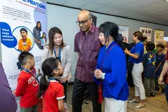 President Tharman Shanmugaratnam and his wife Jane Ittogi (far right, in blue) touring various stations showcasing programmes funded under President’s Challenge 2025.