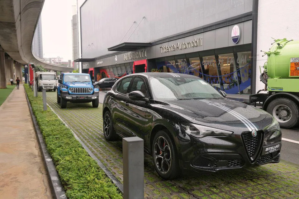 An Alfa Romeo Stelvio Veloce and a Jeep Wrangler Sahara parked at Komoco's premises at 30 Leng Kee Road. 