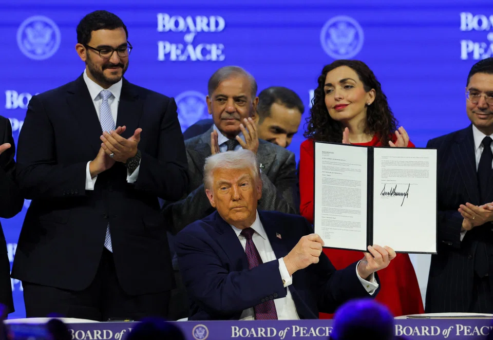US President Donald Trump holds a signed Charter of the Board of Peace, as he takes part in a charter announcement for his Board of Peace initiative, on Jan 22.