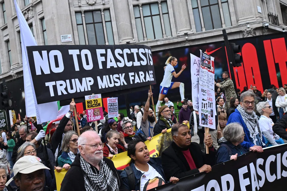 Anti-Trump protesters take part in a march during a demonstration against US President Donald Trump in central London, Britain, Sep 17, 2025. 
