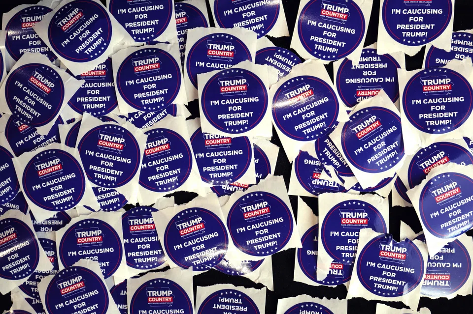 Campaign stickers supporting Trump at a rally in Iowa. The former president was able to sweep the rural counties in the US state, and districts with large concentrations of working-class voters.