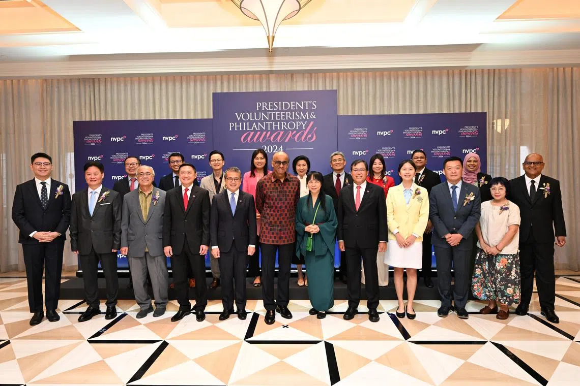President Tharman Shanmugaratnam (centre, in red) and his wife Jane Ittogi (in green) with the PVPA winners on Wednesday.