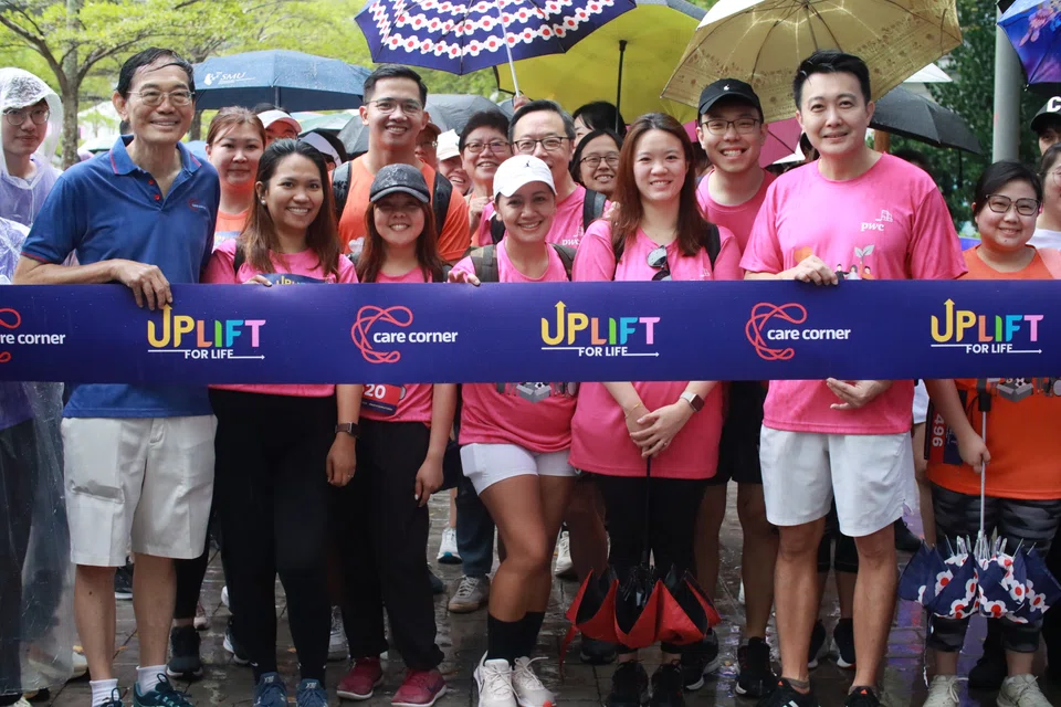 Yong Lum Sung, board chairman, Care Corner Singapore (far left) and Patrick Yeo, deputy markets leader, PwC Singapore (second from right), with ruckathon participants.