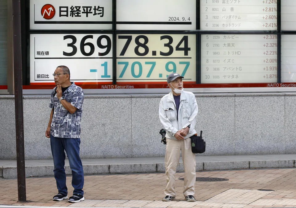 epa11583411 Passersby stand before a stock market indicator board in Tokyo, Japan, 04 September 2024. The Tokyo stock index lost more than four percent, or 1,600 points, following concern on the US economic slowdown. The Nikkei Stock Average plunged 1,638.70 points, or 4.24 percent, to close at 37,047.61.  EPA-EFE/FRANCK ROBICHON