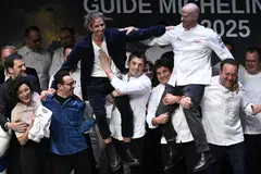 French chefs Hugo Roellinger (L) and Christopher Coutanceau (R) are congratulated after they were awarded with three Michelin stars during the Michelin Guide for France 2025 awards ceremony in Metz, eastern France.