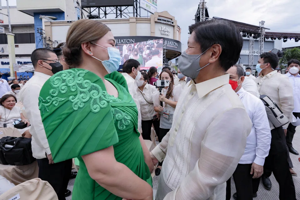 A handout photo made available by the Presidential Photographers Division on Monday (Jun 20) shows Philippines Vice-President-elect Sara Duterte, daughter of outgoing President Rodrigo Duterte, and President-elect Ferdinand 'Bongbong' Marcos Junior at her inauguration ceremony in Davao City on Sunday.  