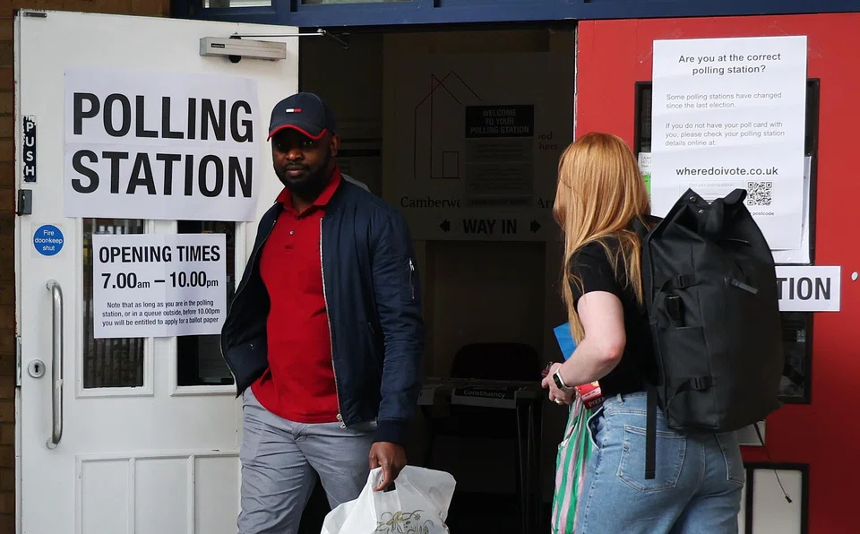 Voters exit a polling station in London. In what was billed as a pivotal moment for the country, 40 per cent of the electorate did not bother to exercise their right to choose an MP or government.