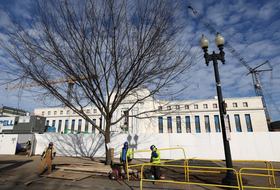 Cranes looming over the construction site of the US Federal Reserve headquarters. The central bank's policy direction and commentary in early 2026 could influence risk appetite and volatility.