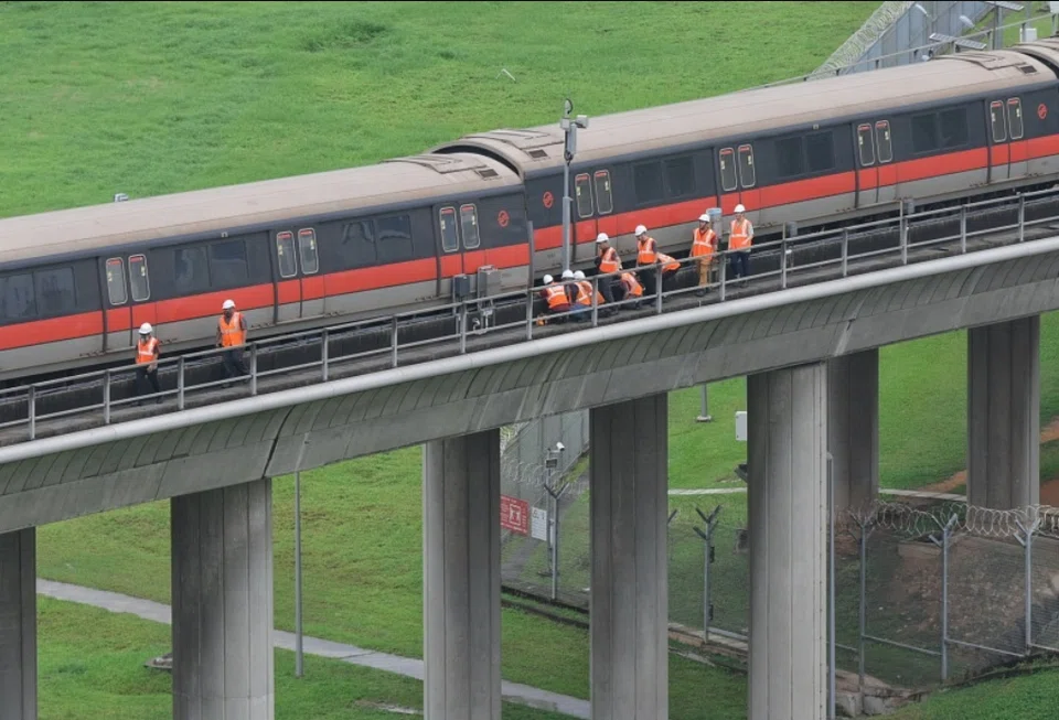 SMRT staff inspecting the carriages of the affected train outside Ulu Pandan Depot at about 1.45 pm on Sep 25. 
