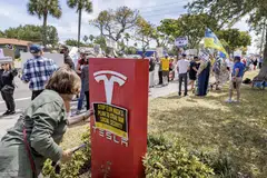 Protestors in front of a Tesla showroom in Fort Lauderdale, Florida, March 22, 2025. 