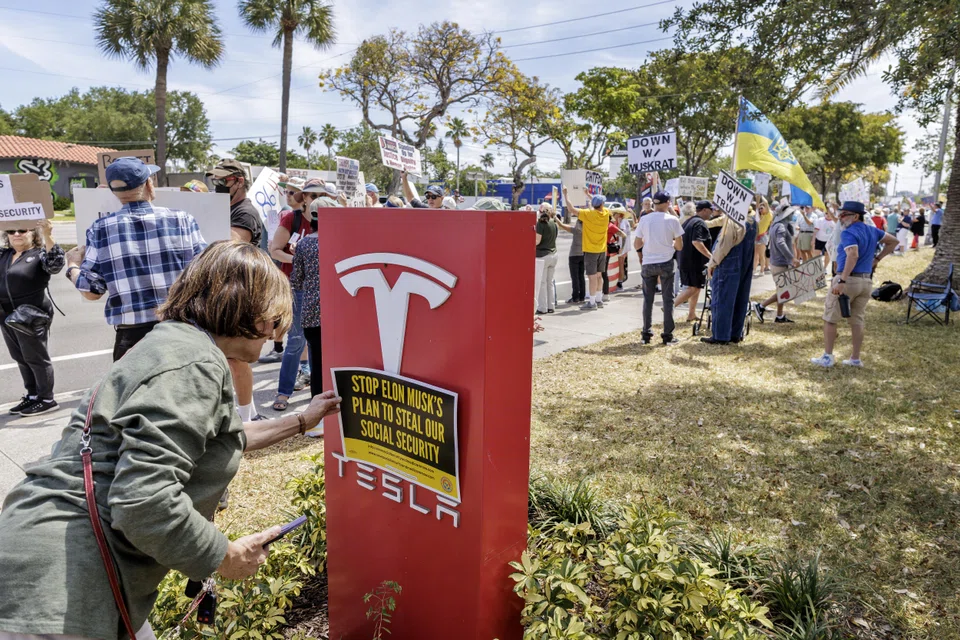 Protestors in front of a Tesla showroom in Fort Lauderdale, Florida, March 22, 2025. 
