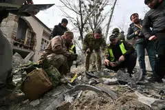 Ukrainian law enforcement officers examine fragments of a rocket at the site of a missile attack in Kyiv on Mar 25, 2024. A US official says Chinese companies are providing critical components for Russian military systems. 