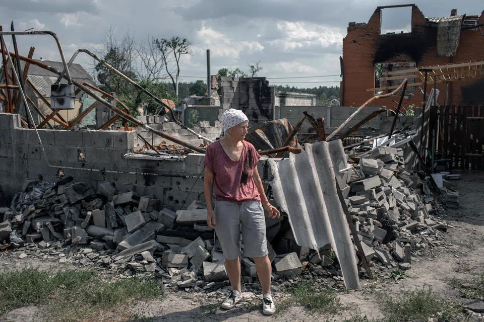 Valentyna Chernenko, 74, surveys the wreckage of her home, destroyed in shelling in mid-March, in the village of Moschun, near Kyiv, Ukraine, on Jul 5. The Ukraine conflict entered its 150th day over the weekend, and there is little certainty on the likely length or outcome of the war.