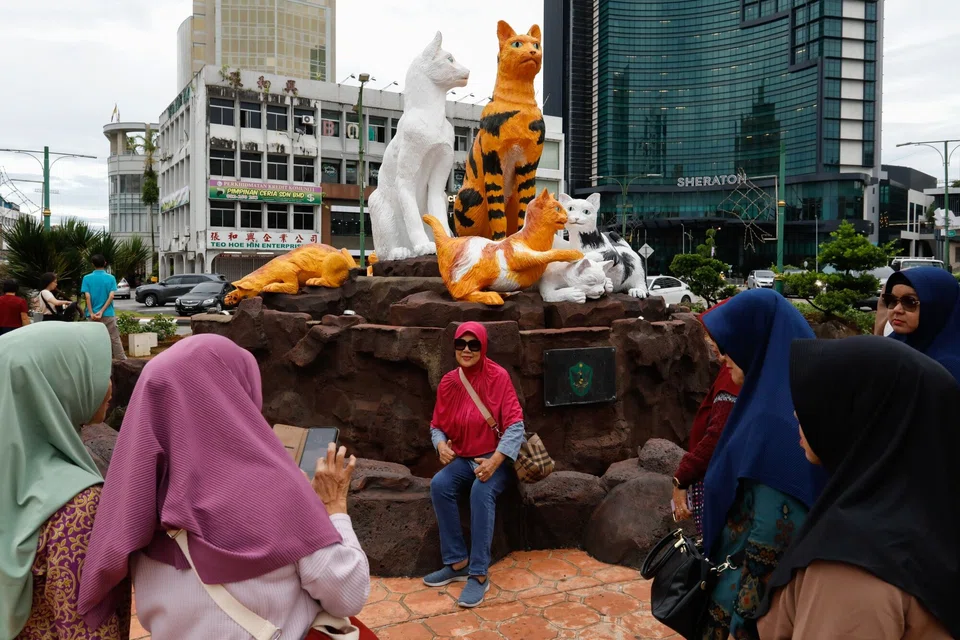 Tourists takes photos in front of the cat statue landmark in Kuching, the capital city of Sarawak, Malaysia. The state plans to power the public transportation system of its capital city - Kuching - using hydrogen power by 2025.