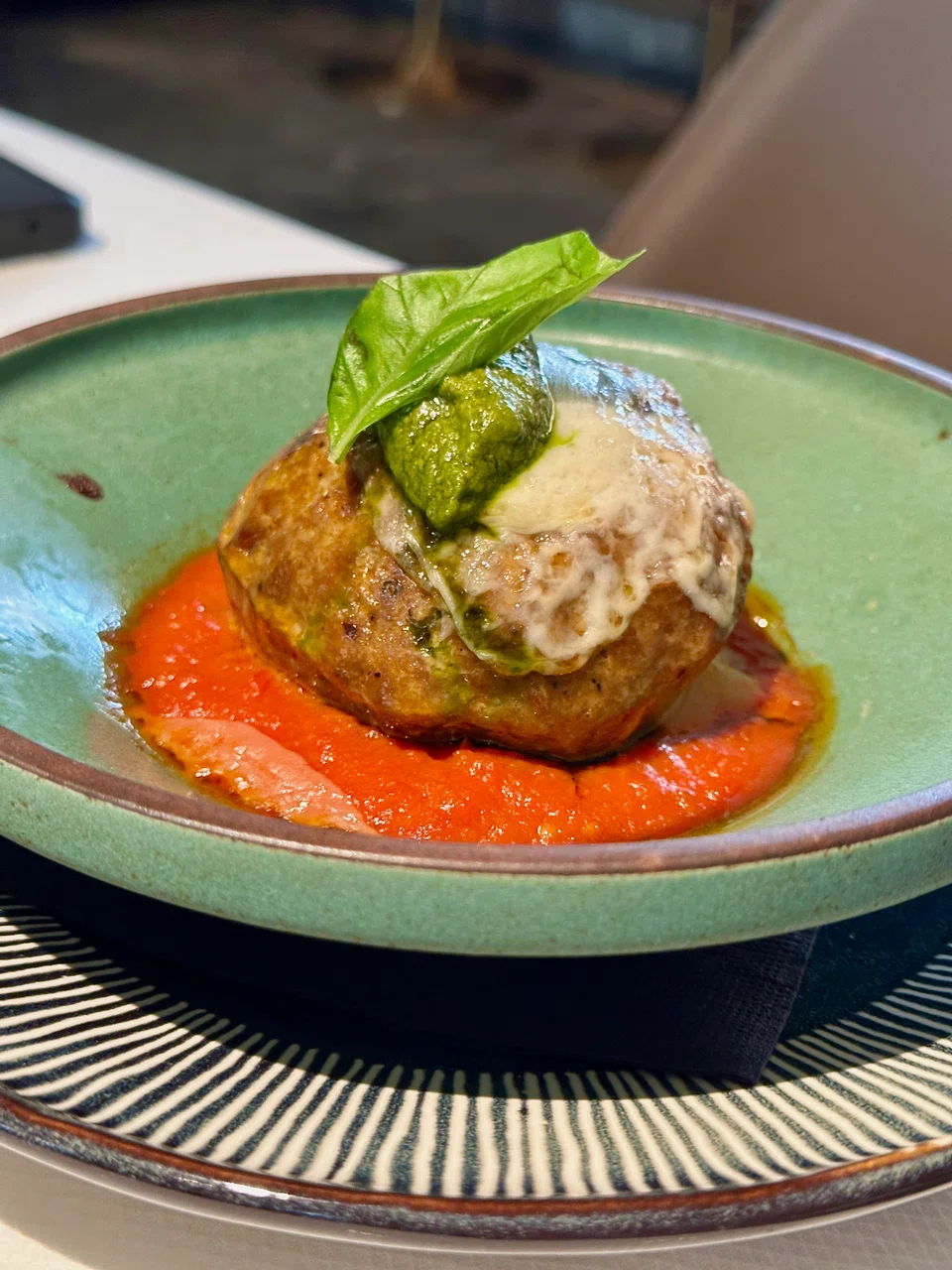 Polpettone is a cheesy stuffed meatball in savoury tomato sauce.