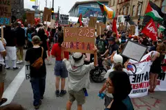 A woman holding a placard reading "Project 2025 is un-American" in an anti-Trump protest outside the venue of the Republican National Convention in Milwaukee, Wisconsin, Jul 15. 