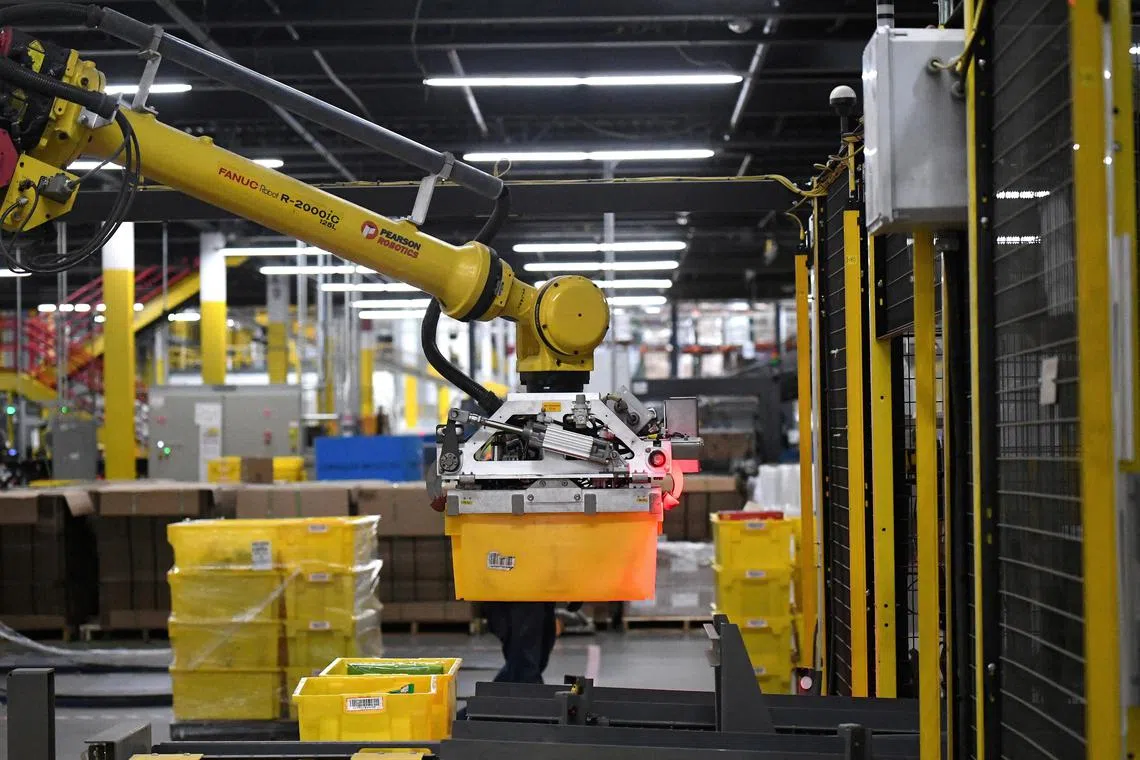 A robotic arm picks up sorting containers at an Amazon fulfillment centre in the United States.