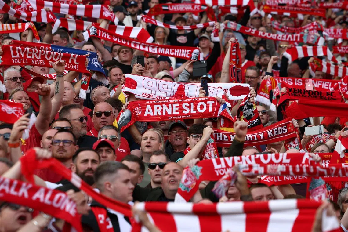 Liverpool fans wave scarves at Anfield during their club's 5-1 win over Tottenham on Sunday, a result that was enough to win the Premier League trophy.