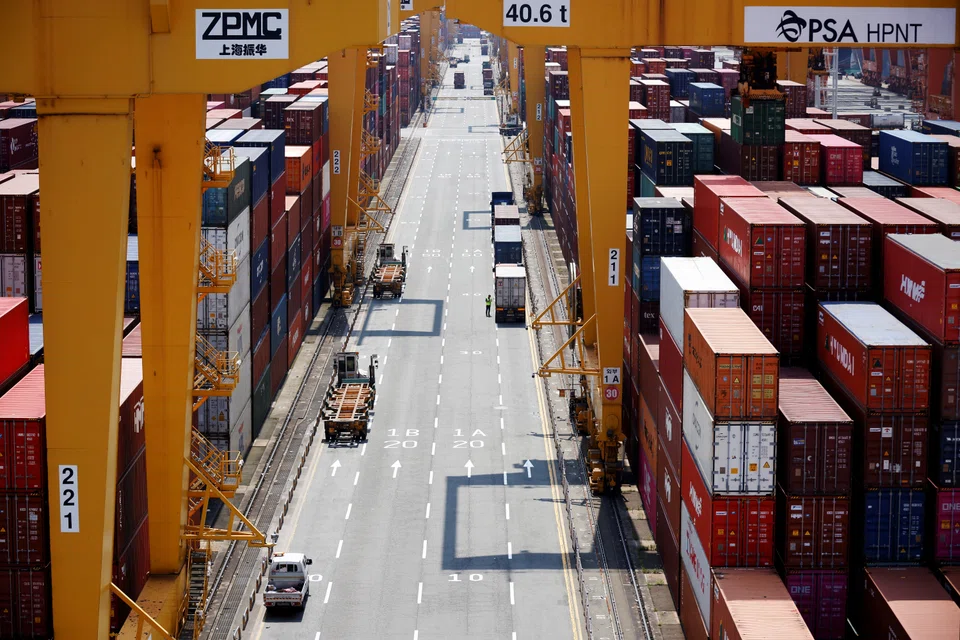 A truck driver about to transport a shipping container at Pusan Newport Terminal in Busan; inventories at South Korea's 100 biggest firms by revenue are rising at the fastest pace in a decade.