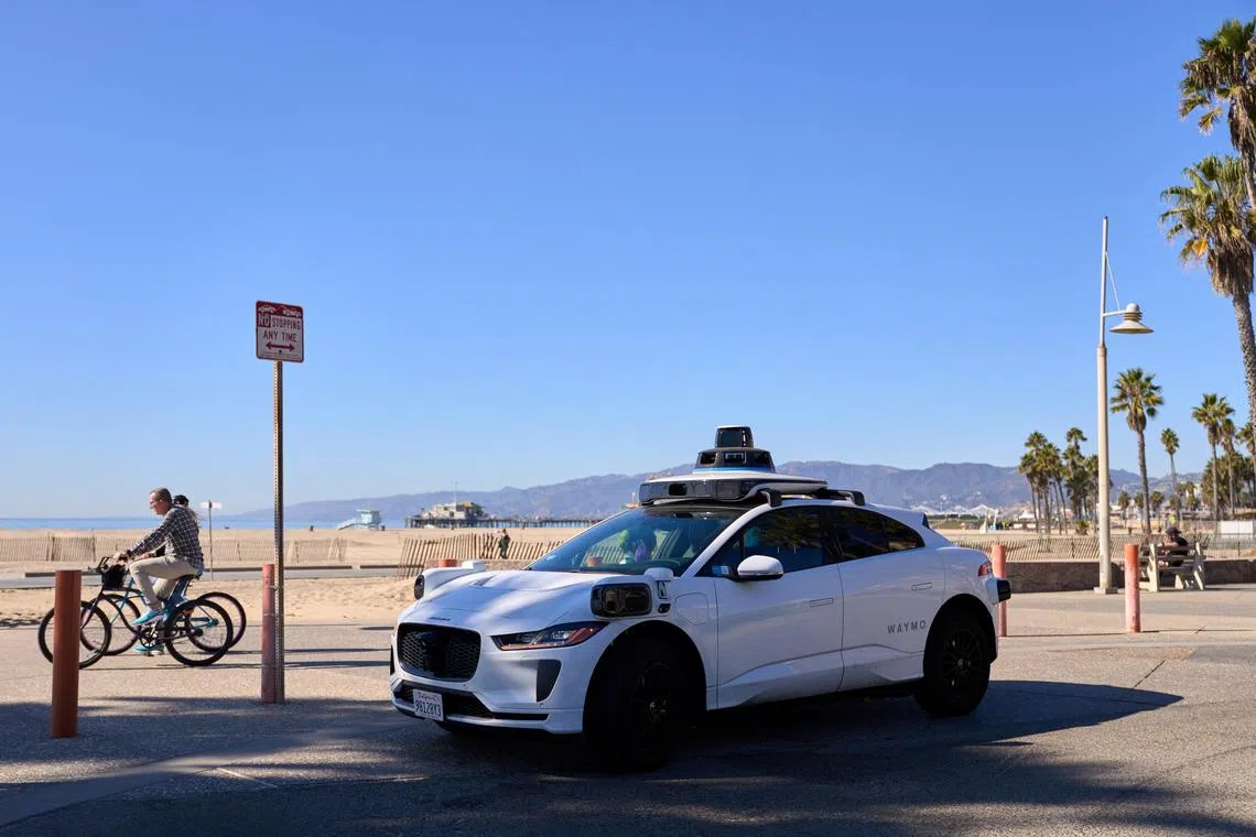 epa11731962 A Waymo autonomous self-driving Jaguar robotaxi waits for a passenger in Los Angeles, California, USA, 20 November 2024. On 12 November 2024, Waymo opened its autonomous self-driving robotaxi service to anyone in a nearly 80 square mile area of Los Angeles County, marking its largest expansion yet. Waymo, owned by Google parent Alphabet, closed a $5.6 billion funding round in October to expand its robotaxi service across the US.  EPA-EFE/ALLISON DINNER
