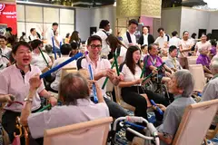 Hong Leong Foundation governors Quek Kon Hui (second from left) and Michelle Kwek (third from left) playing rhythmic games with senior beneficiaries at Silver Dance Fiesta.