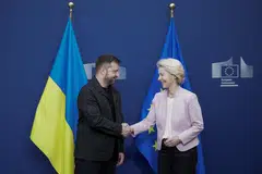 European Commission President Ursula von der Leyen shakes hands with Ukrainian President Volodymyr Zelensky in Brussels, Belgium, where he will participate in a meeting of European leaders, Aug 17, 2025. 
