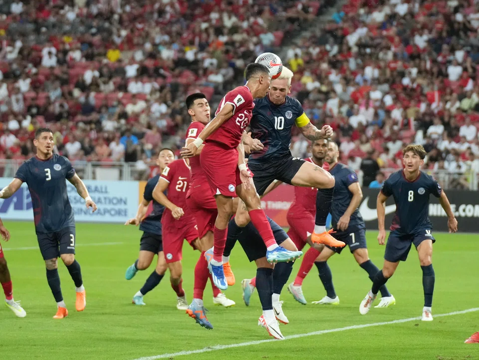 Singapore's Shawal Anuar (wearing the No 20 jersey) challenging Guam's Jason Cunliffe for the ball in their World Cup qualifier at the National Stadium on Oct 12.