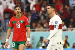 Portugal’s Cristiano Ronaldo looks dejected after being eliminated from the World Cup, as Morocco’s Jawad El Yamiq looks on.