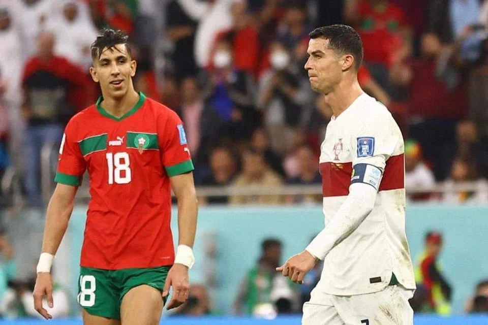 Portugal’s Cristiano Ronaldo looks dejected after being eliminated from the World Cup, as Morocco’s Jawad El Yamiq looks on.