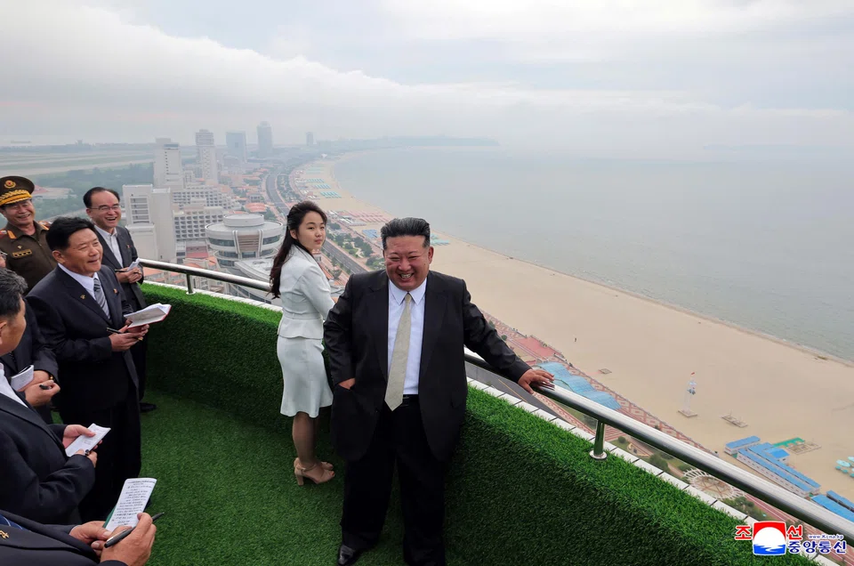 North Korean leader Kim Jong Un and his daughter Kim Ju Ae stand on a balcony during a ceremony to celebrate the completion of the Wonsan Kalma Coastal Tourist Zone.