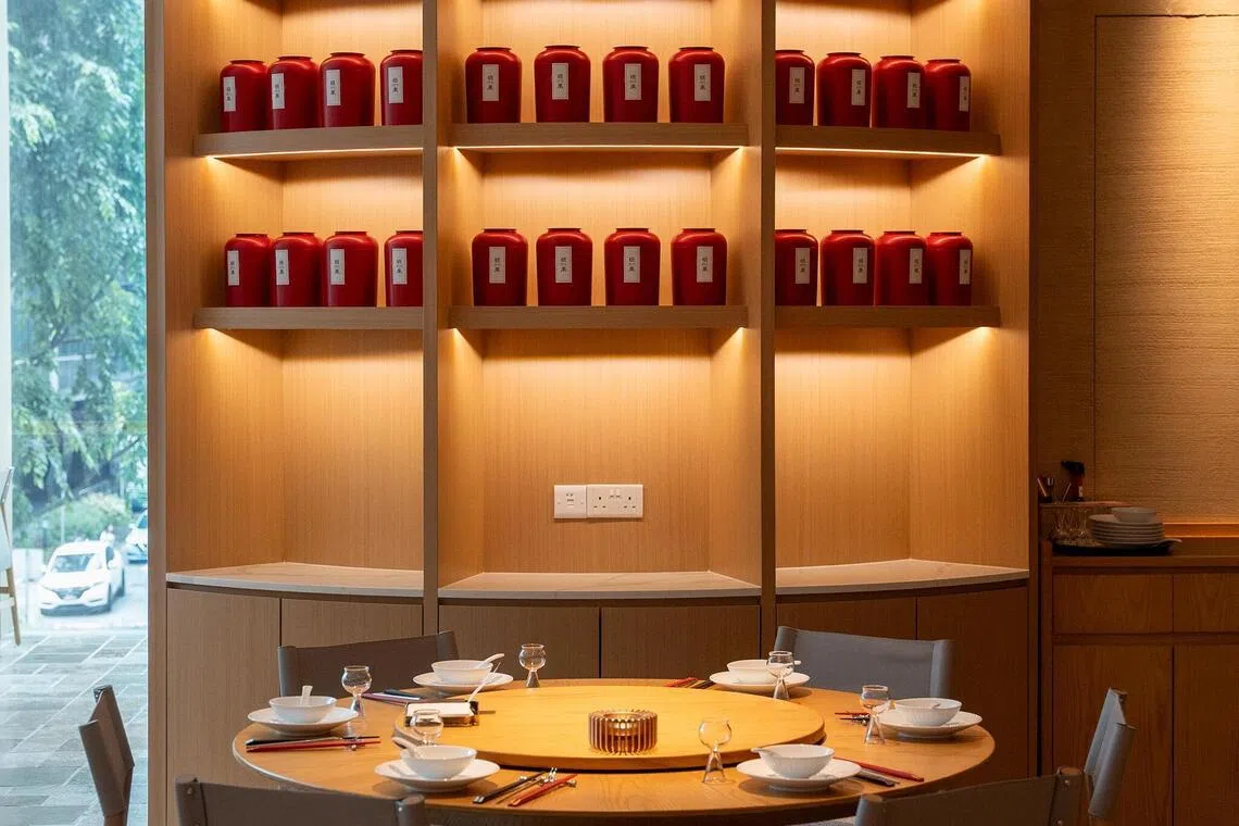 Ban Lan features a wall of red tea tins as its focal point.
