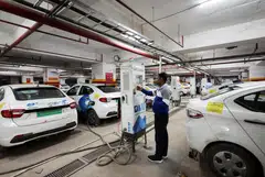 A man charges an electric vehicle in Gurugram. India, one of the world’s fastest growing oil markets, has lagged major economic peers in Europe and Asia in the adoption of EVs. 