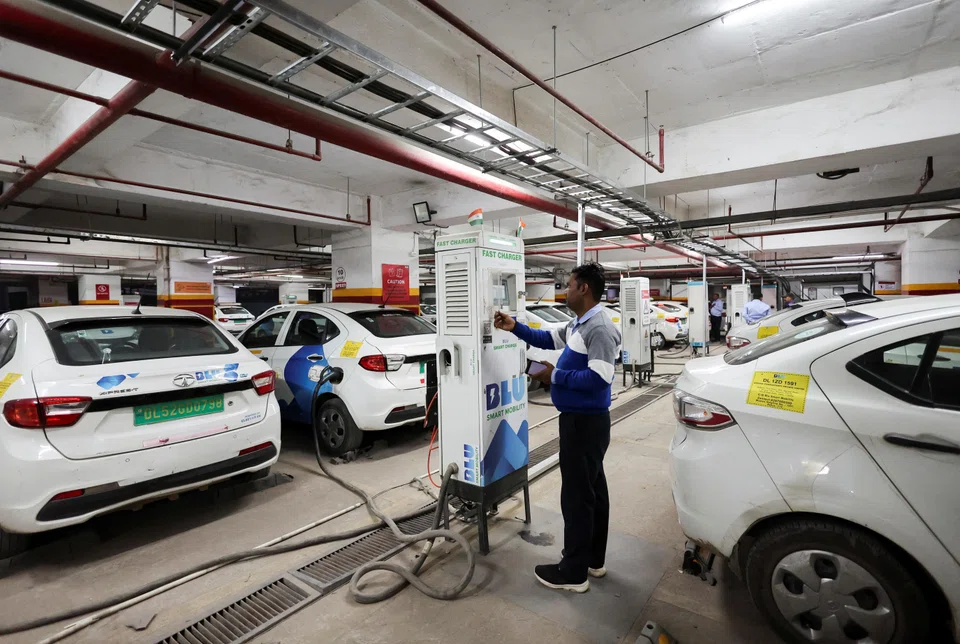 A man charges an electric vehicle in Gurugram. India, one of the world’s fastest growing oil markets, has lagged major economic peers in Europe and Asia in the adoption of EVs. 